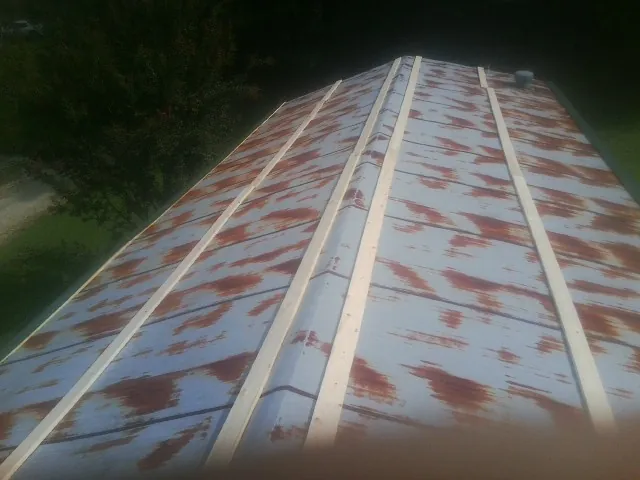 Rusted metal roof panels with new wood purlins before replacement — Storm Damage Roof Repair in Seth by Roofing Brothers